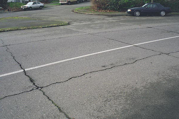 Severe transverse reflection cracking over joints in the concrete substrate